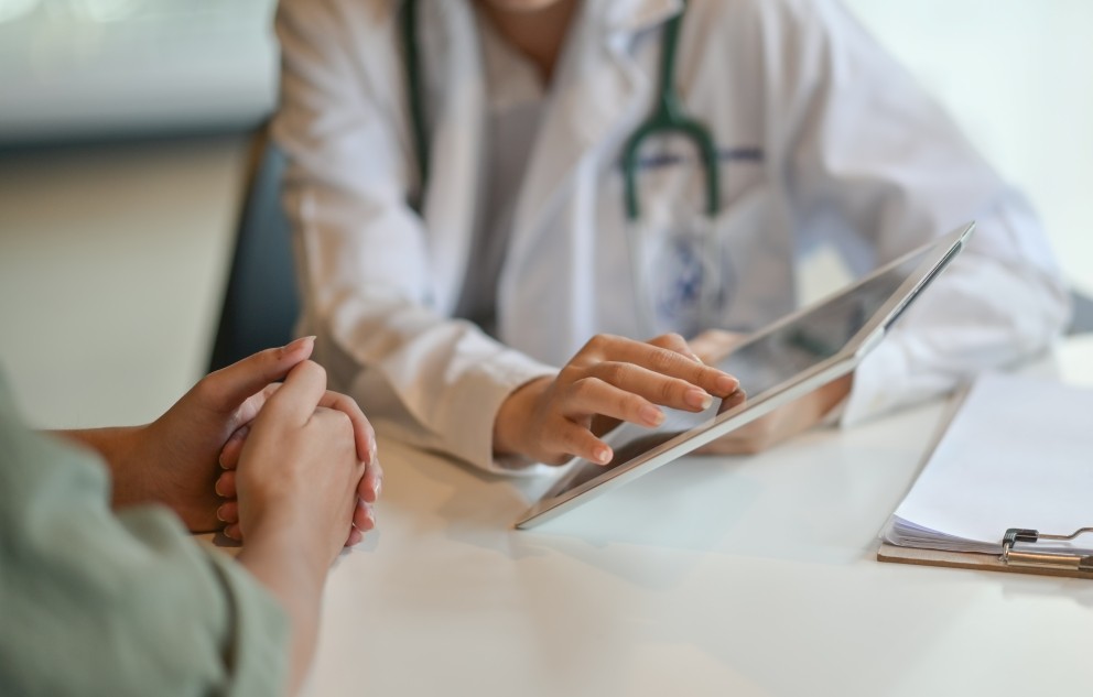 Female physician with a patient looking at a tablet